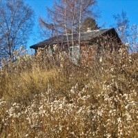 This photo was taken during an afternoon walk through Listvyanka, a wonderful little village stretching for 5 kilometers along the shores of Lake Baikal in eastern Russia. The homes here are mostly the traditional, wooden style of Siberia, with one or two rooms and brightly coloured window frames or elaborately carved shutters.  